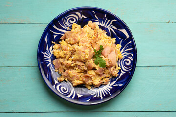 Scrambled eggs with ham for breakfast