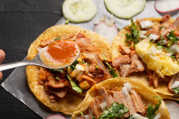 Pork tacos called al pastor with pineapple and sauce. Mexican food