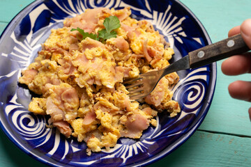 Scrambled eggs with ham for breakfast