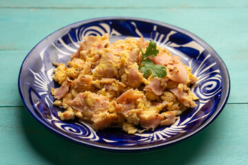 Scrambled eggs with ham for breakfast
