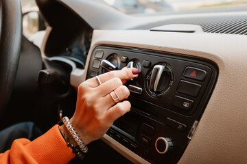 The girl driver adds a level of ventilation and climate control with air conditioning on the dashboard in her car