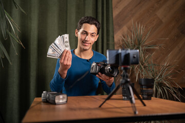 Video training for beginner photographers, online courses. A Muslim man holds a pack of one hundred...