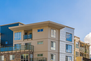 Brand new apartment building on sunny day in BC, Canada. Architectural details of modern apartment building