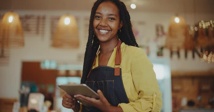 Confident and successful young black female entrepreneur, young african american woman, small business owner with tablet computer