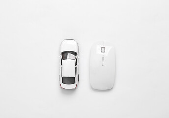Toy model car and pc mouse on white background