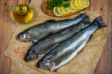 Three raw trout ready to be cooked.