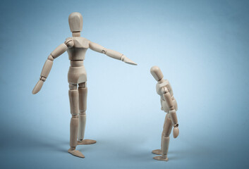 Angry parent puppet points with hand and scolds the child. Negative emotion, teenage problem concept. Isolated on blue