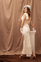 a girl in a dress with a slit at the bedside table