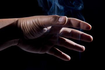 Naklejka na ściany i meble male hand with magic white smoke.