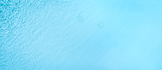 Transparent blue clear water surface texture with ripples, splashes and bubbles. Abstract summer...