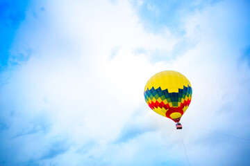Balloon against the blue sky in flight, colorful fun entertaining form of transport, flight in the air of the balloon, the concept of dream and happiness