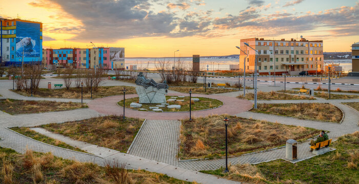 Anadyr, Chukotka, Far East Russia - June 9, 2014. Panorama of the square in the city of Anadyr. A beautiful view of the monument to the Chukchi writer Yuri Rytkheu and colorful houses with billboards.