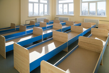 New baby beds in an empty preschool bedroom...new children's beds for toddlers, in kindergarten.