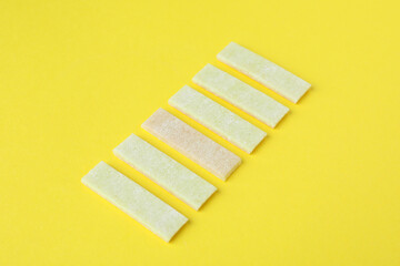 Chewing or bubble gum on yellow background