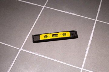 Contractor equipment on gray tiles.