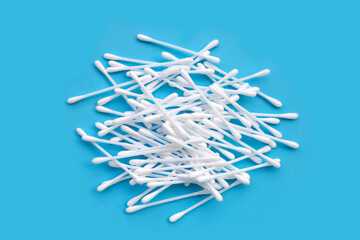 Cotton buds on blue background.