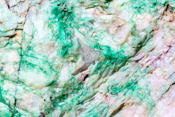 Obraz na płótnie Canvas Background from dracocene crystals of stones. Fluorite stone in the rocks of the adit. Mineral stones in their natural environment. Semiprecious stones texture.