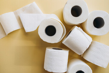 rolls of white toilet paper on a beige background with space for text. toilet paper top view copy space	
