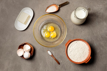 Products for baking, kneading dough. Top view on a gray background.