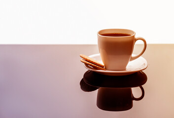 Coffee cup on table. White tea mug with a saucer on a glossy table