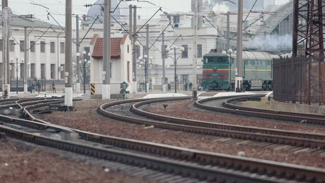 Railway locomotive. Front view. Old soviet diesel vehicle. Front view of soviet powerful diesel locomotive on railroad. Train at the railway station. Suburban electric train.