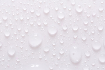 Water drops on glass on a white background. Water drop texture as background. Freshness after the rain. Ecology of wet clean nature. steam in the shower