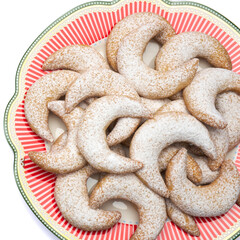 Traditional German or Austrian Vanillekipferl vanilla kipferl cookies on decorated ceramic plate