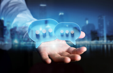 Businessman in dark using digital speech bubbles talk icons. Minimal conversation or social media messages floating over user hand. 3D rendering