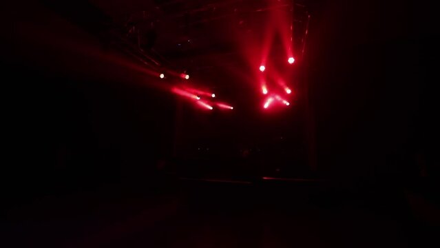 Static rays of red light on the concert stage before the performance of a rock band, light readiness before the concert.