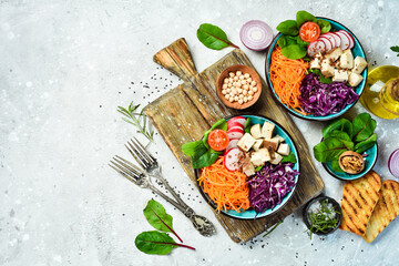 detox Buddha bowl with Tofu cheese, spinach, cabbage, radishes and carrots. The concept of dietary nutrition. On a stone background.