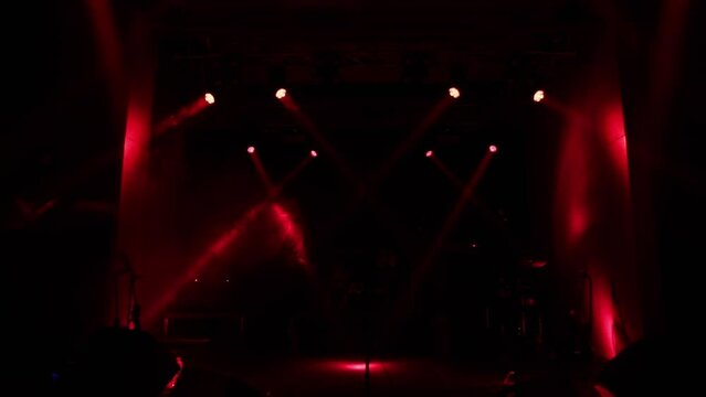 Static rays of red light on the concert stage before the performance of a rock band, light readiness before the concert.