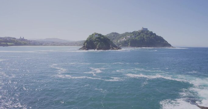 View of Isla de Santa Clara and Igueldo from Urgull. San Sebastian, Spain.Picturesque aerial view of turquois water of La Concha Bay of San Sebastian with Santa Clara Island and moored pleasure.