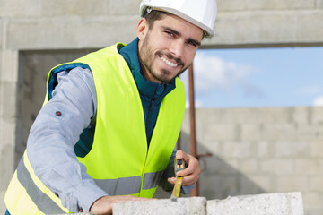 a craftsman is erecting a wall