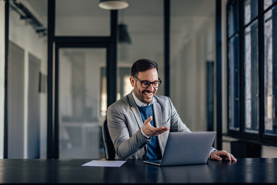 Joyful caucasian man, attending an online meeting, laughing with his colleagues.