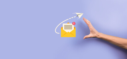 Businessman hand holding letter icon,email icons.Contact us by newsletter email and protect your...