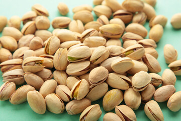 Pile of Pistachios on the green background.