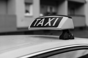 Taxi sign on a German taxi from the right in black and white