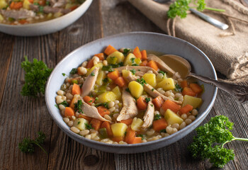 Chicken soup with vegetable, potatoes and white beans