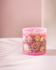 Handmade candles with dried flowers unique design. Scented candles decorated by dry leafs and blooms.