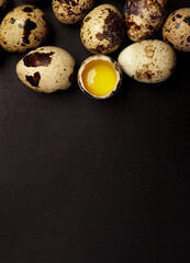 Quail eggs on black background. Healthy food concept. Top view