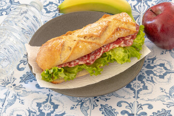 sausage sandwich with fresh fruits on a table