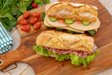 dry sausage and turkey fillet sandwich close-up on a wooden board
