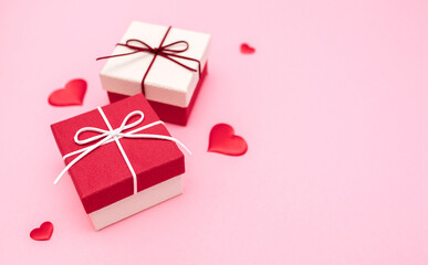Valentine's Day. Gifts in the form of hearts on a pink background with the inscription love. Copy space for text. The concept of romance and love.