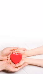 Man give red heart to kid as couple. Healthcare and hospital medical concept. Donation...