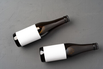 Beer bottle, on gray stone background, top view, with copy space for text