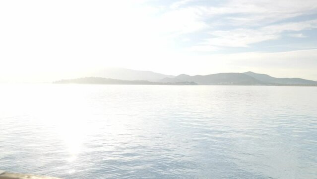 Shot of a woman looking at the sea on a sunny day. UHD quality