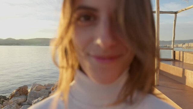 Dolly in shot of a woman walking towards the camera while looking at the lens until extreme closeup. UHD quality