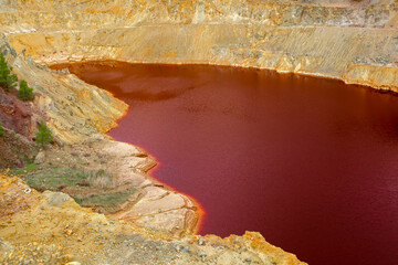 The Amazing Unusual Red Bloody Lake in the Abandoned Career for the Extraction of Gold and Other...