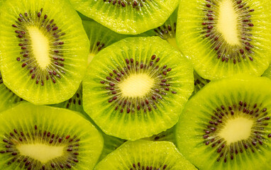 Kiwi closeup as background. Ripe kiwi fruit in the cut. Kiwi seed texture.
