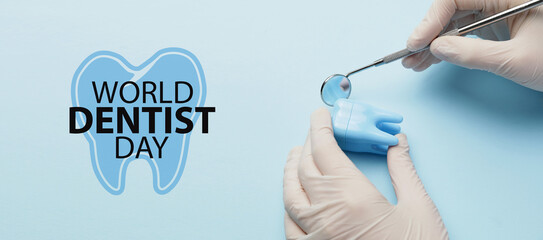 Dentist with mouth mirror and tooth on color background. World Dentist Day